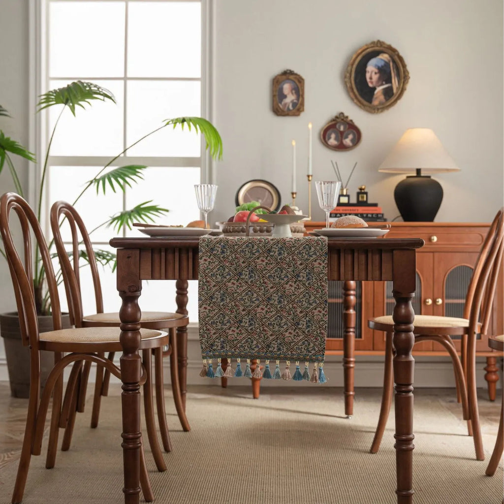 Dark blue Nordic jacquard stripe table runner with bouquet pattern and tassel fringe on a wooden table