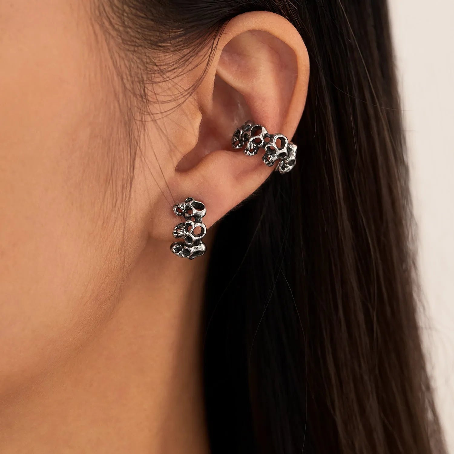 Stainless steel hollow skull earrings with geometric design and ear clips