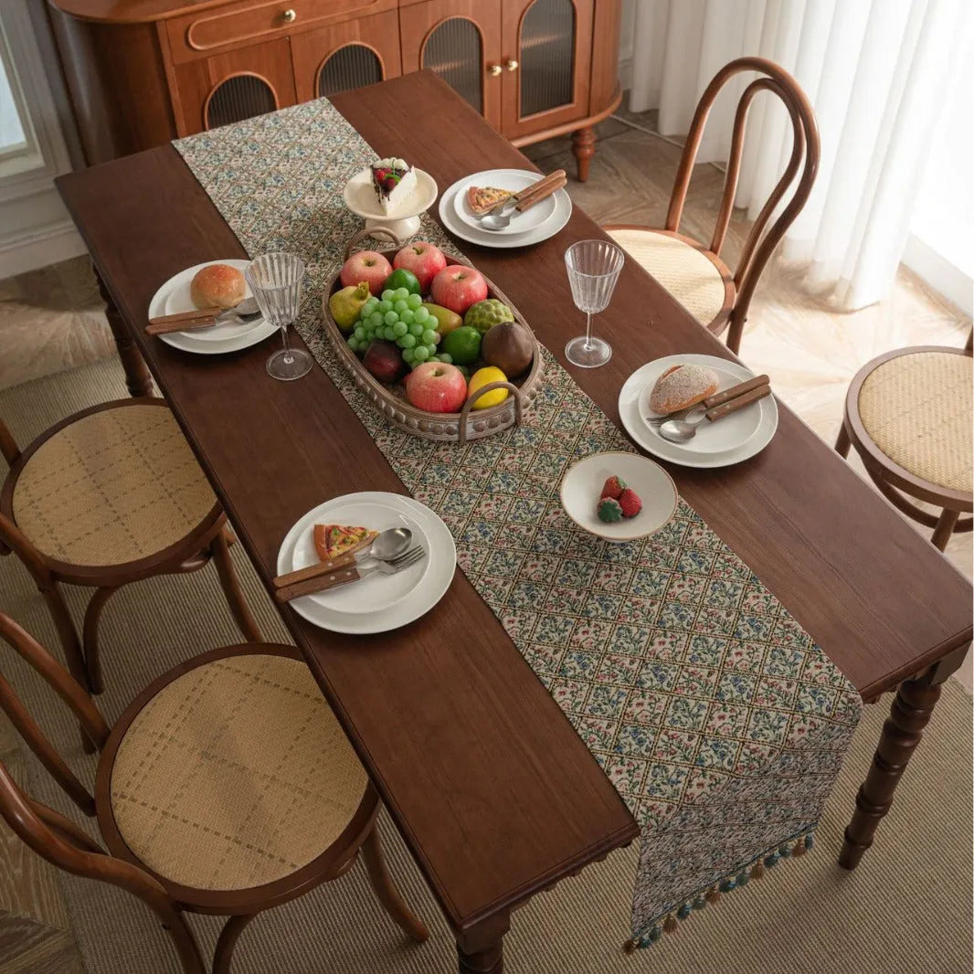Dark blue Nordic jacquard stripe table runner with bouquet pattern and tassel fringe on a wooden table