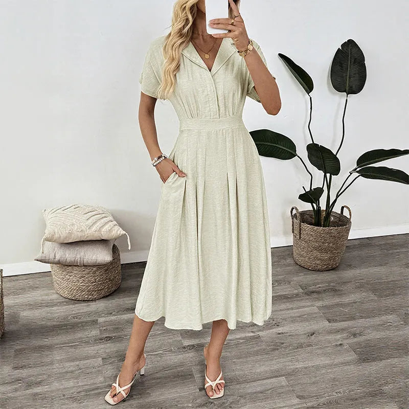 Light green women's shirt dress with lapel collar, waist tie, and hidden skirt pockets on a hanger.