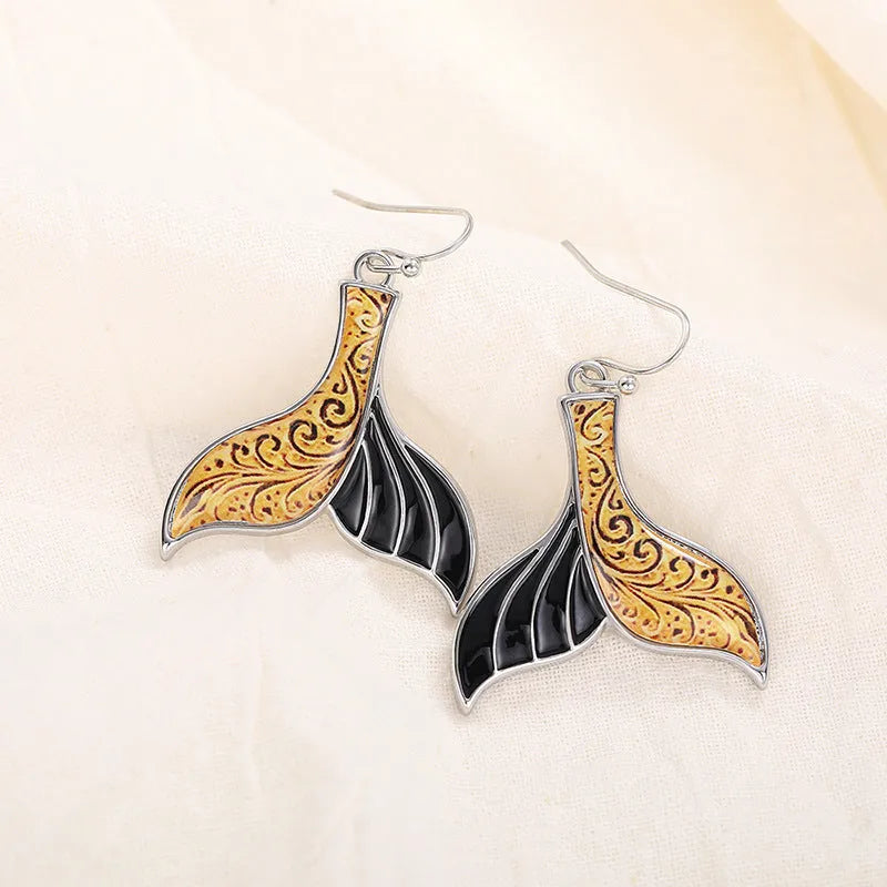 Women's white gold fishtail earrings with whale design elements in retro style