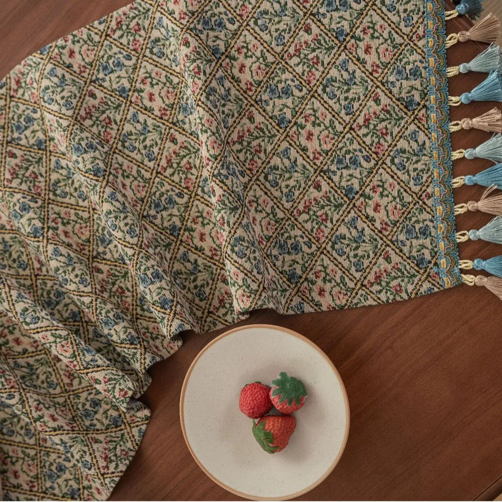 Dark blue Nordic jacquard stripe table runner with bouquet pattern and tassel fringe on a wooden table