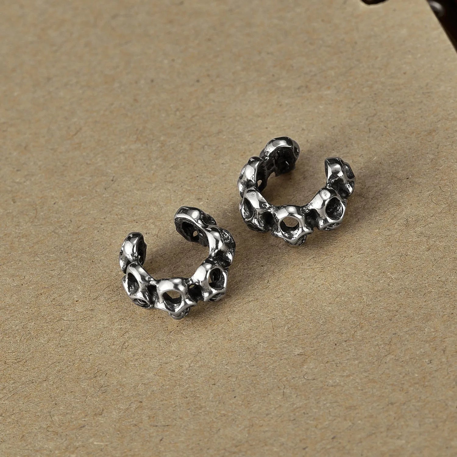 Stainless steel hollow skull earrings with geometric design and ear clips