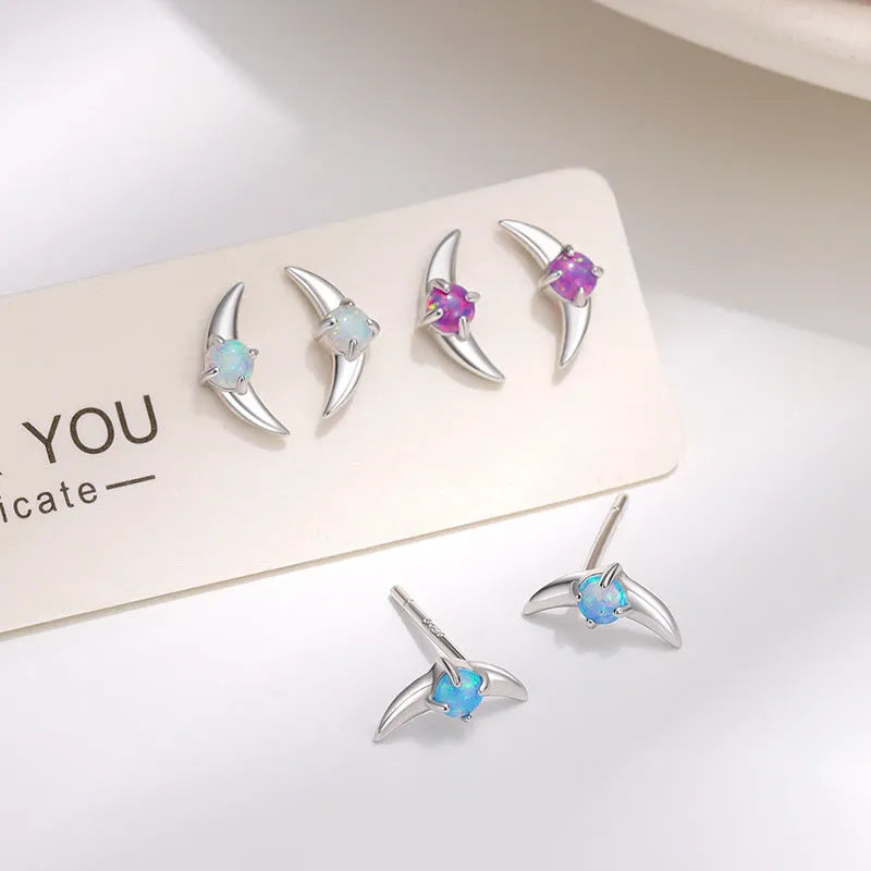 A pair of women's geometric drop earrings made from 925 sterling silver with coloured stones, shown in a gold tone finish.