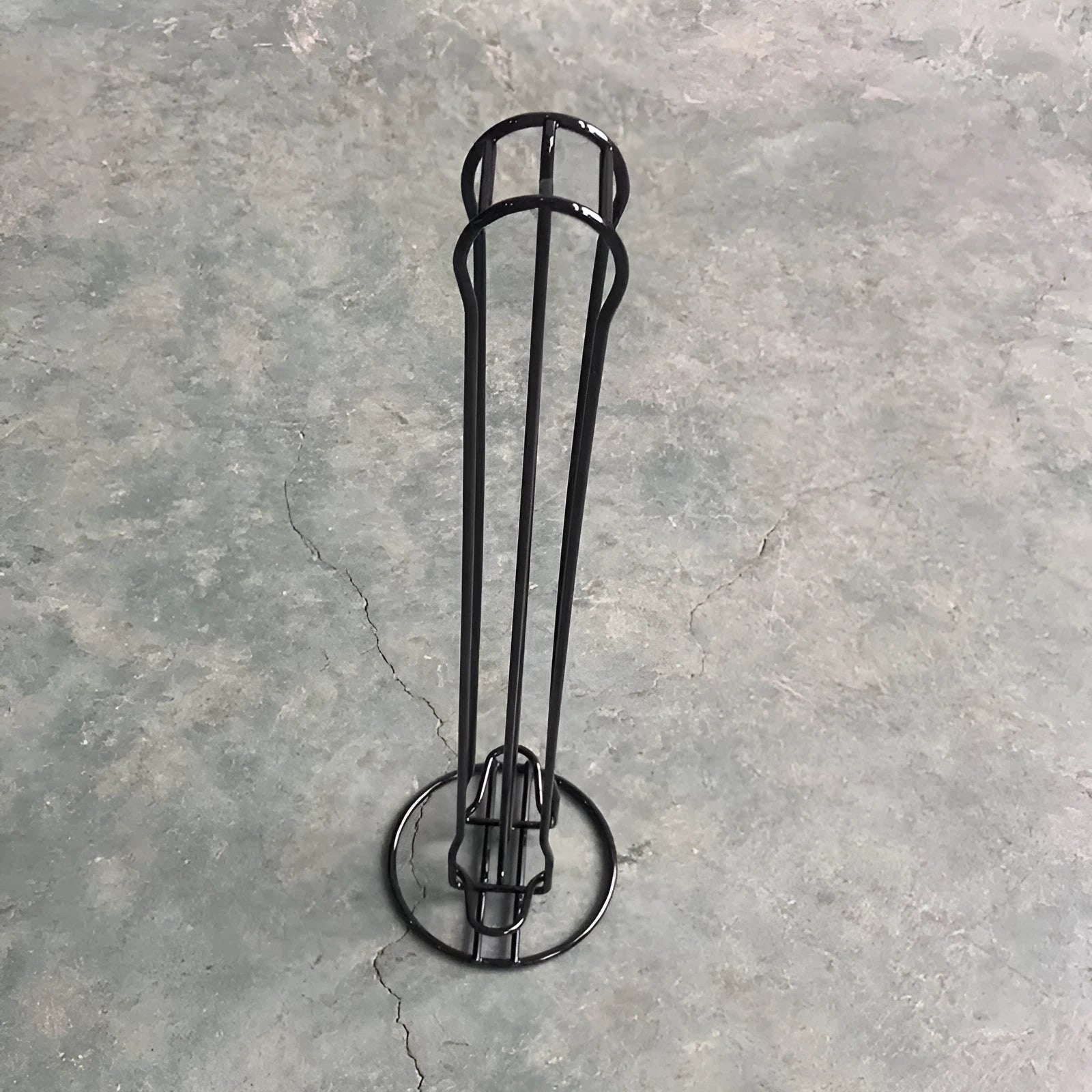 Iron coffee capsule storage rack holding pods on tiered shelves with compact dimensions