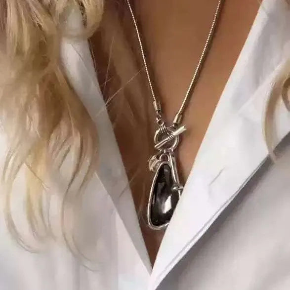 Long geometric plaid pendant necklace on a snake bones chain in alloy metal.