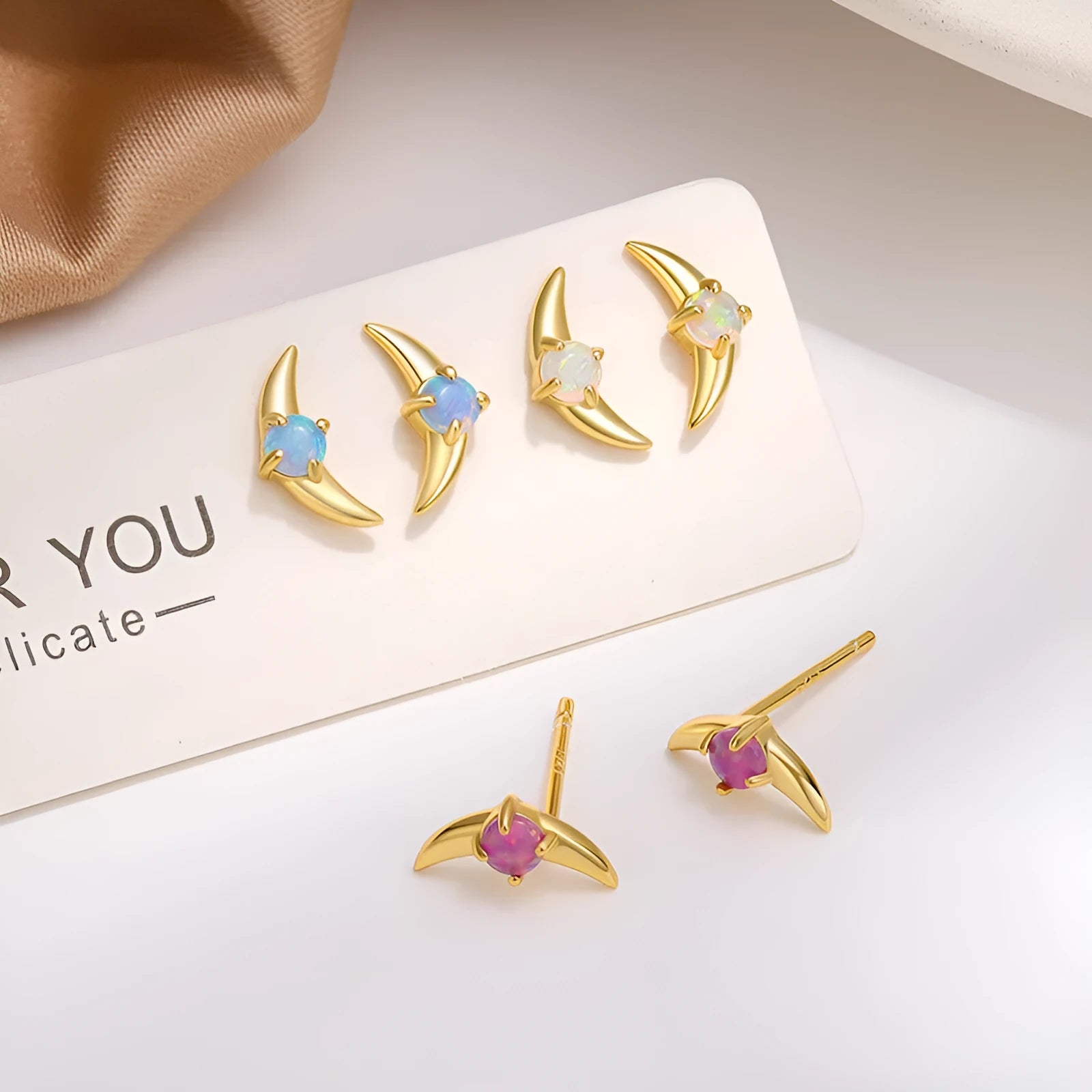 A pair of women's geometric drop earrings made from 925 sterling silver with coloured stones, shown in a gold tone finish.