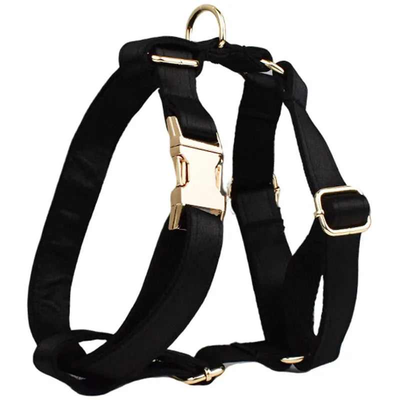 A complete cloth dog accessory set showing a collar, leash, chest strap, vest, and decorative bow in matching colours.