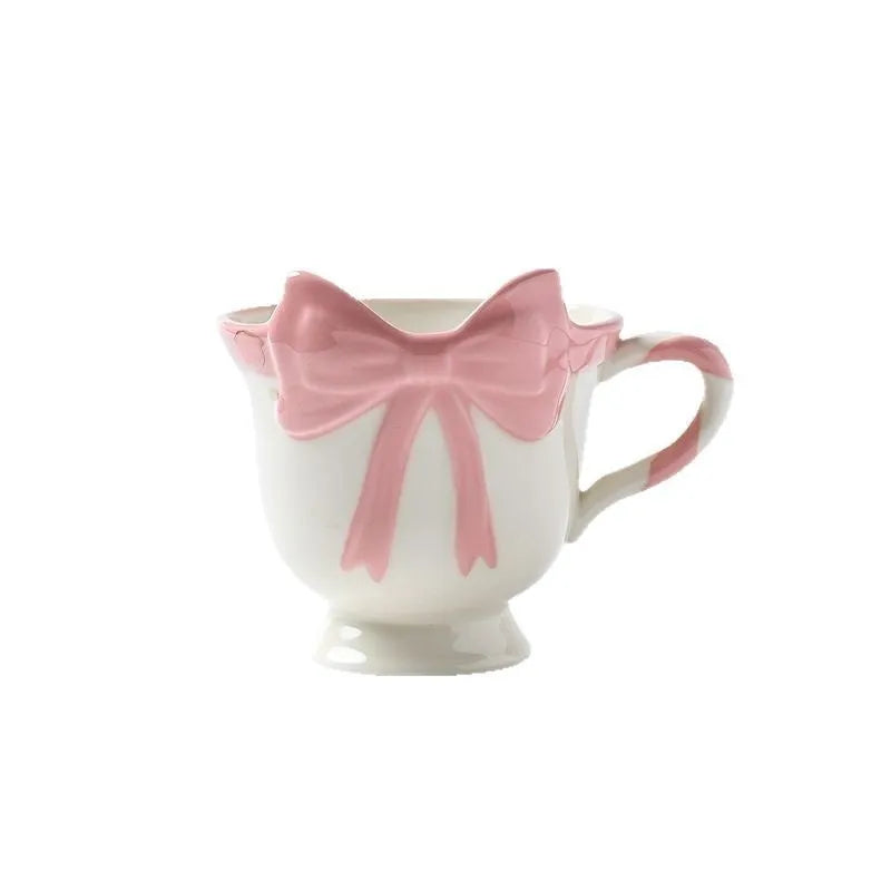 Heart-shaped ceramic mug with decorative bow design in white powder or black pink colour