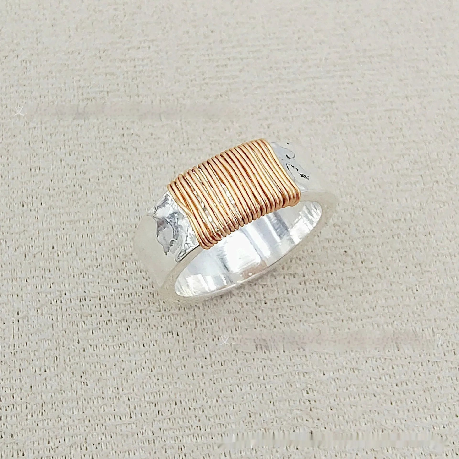 Copper bracelet ring with geometric coil design in silver gold colour on wrist