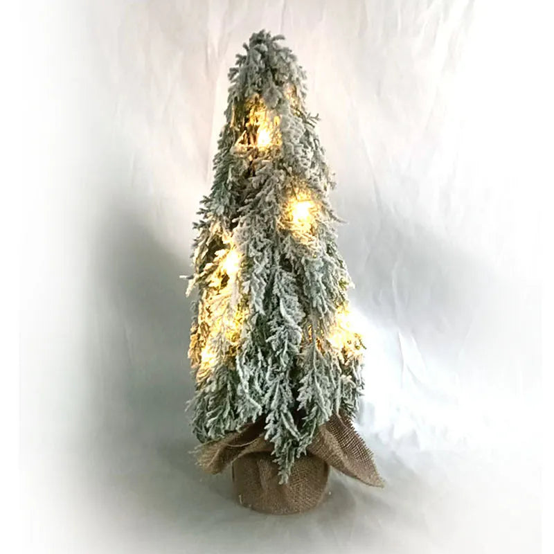 Small 24-inch artificial Christmas tree with white PE snow spray finish, green branches, built-in lights, and a red ornament