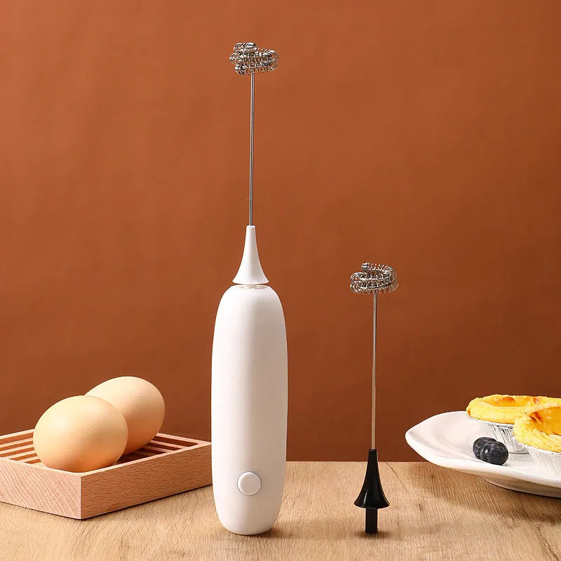 Black and white hand-held electric milk frother blender for coffee preparation
