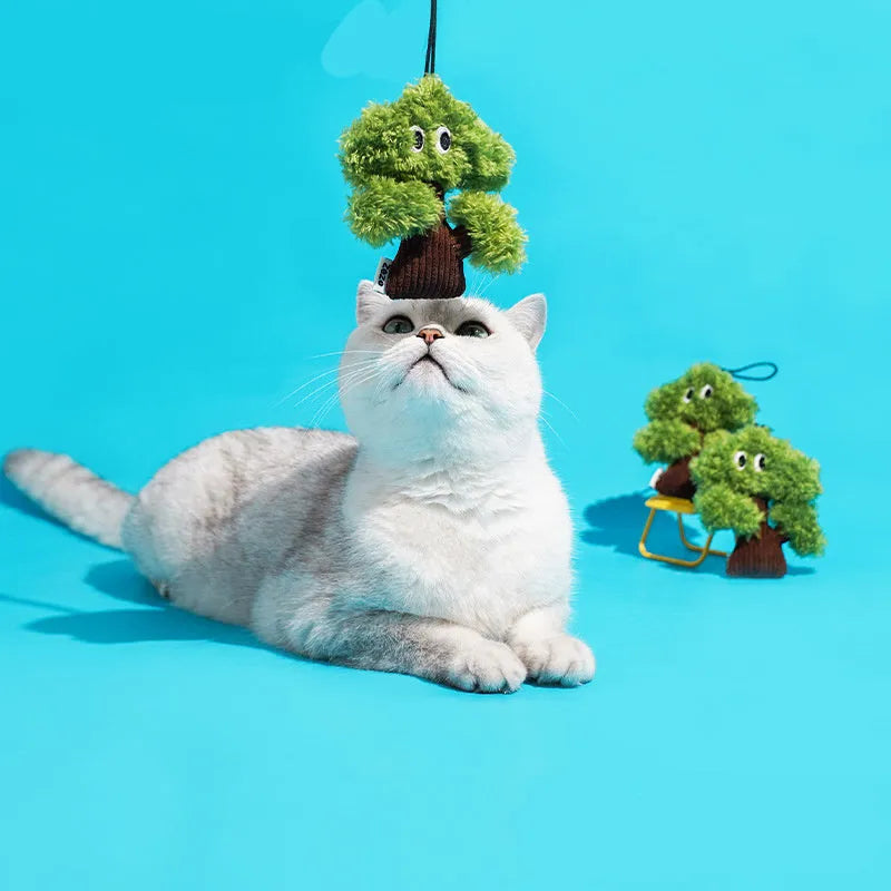 Green pine tree shaped cat toy pendant with a hanging loop, shown next to a tape measure indicating 12cm length.