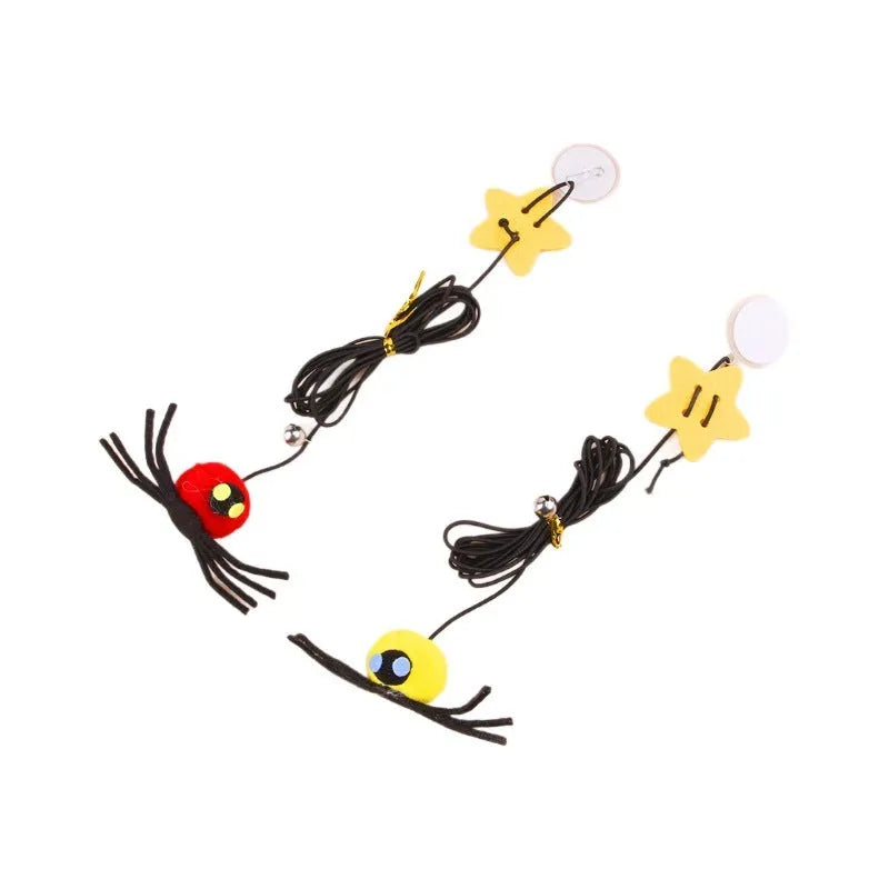 Red cat toy hanging from door with elastic rope, feather stick, bell, and spider decoration