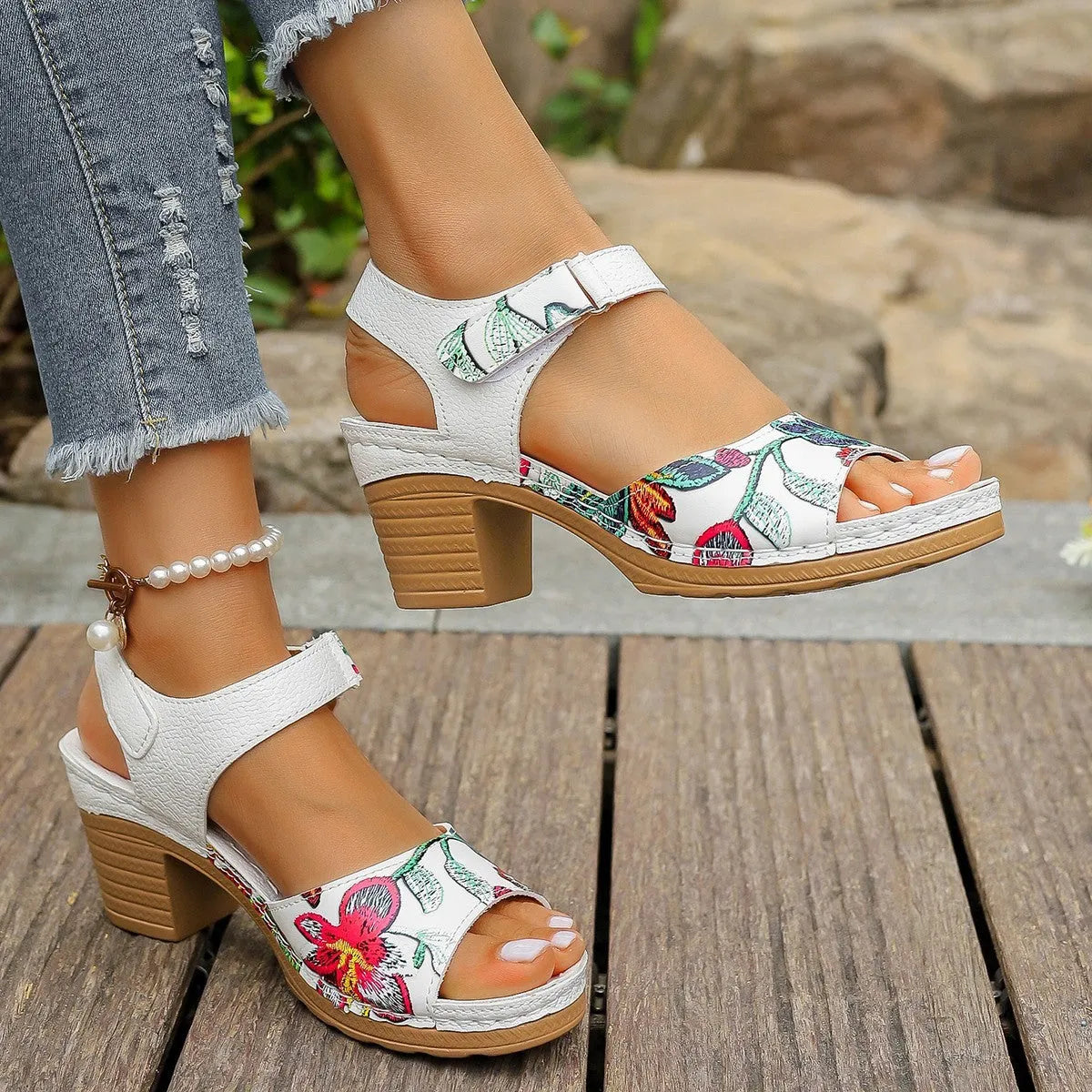 White women's high heel sandals with an adjustable Velcro strap buckle on the ankle.