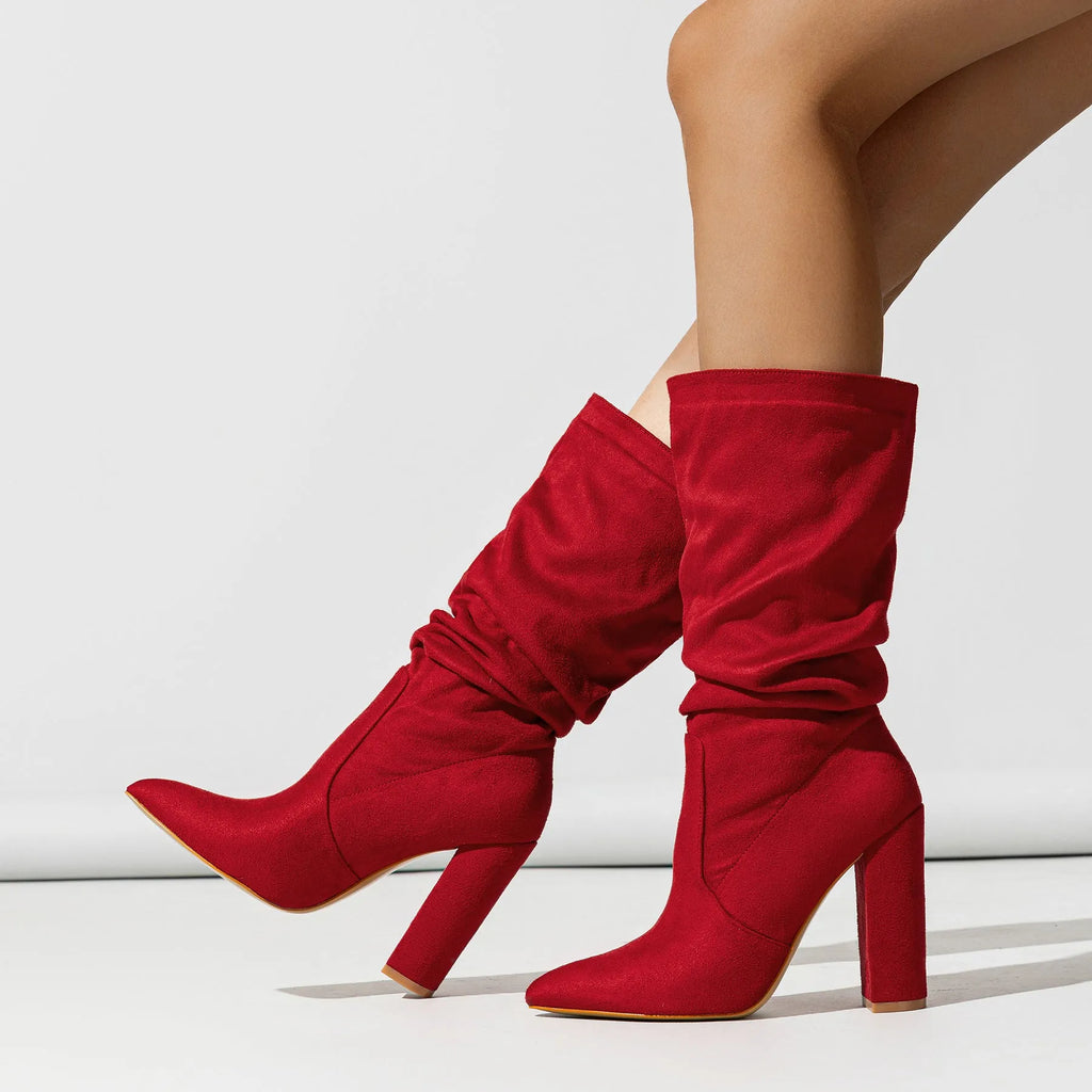 Women's black suede ankle boots with a chunky high heel and pointed toe.