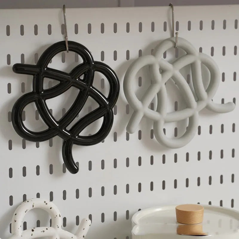 Ceramic heat proof mat with irregular organic shape in solid colour for dining table protection