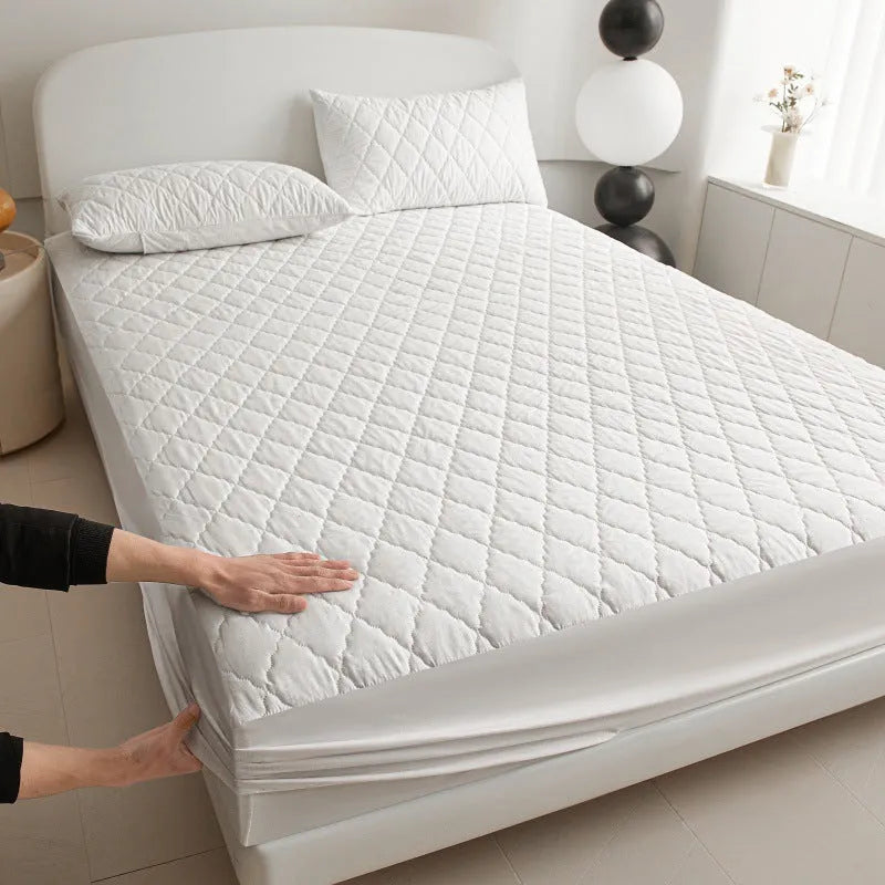 Diamond lattice quilted bamboo fibre waterproof mattress protector set with fitted sheet and pillowcases in grey.