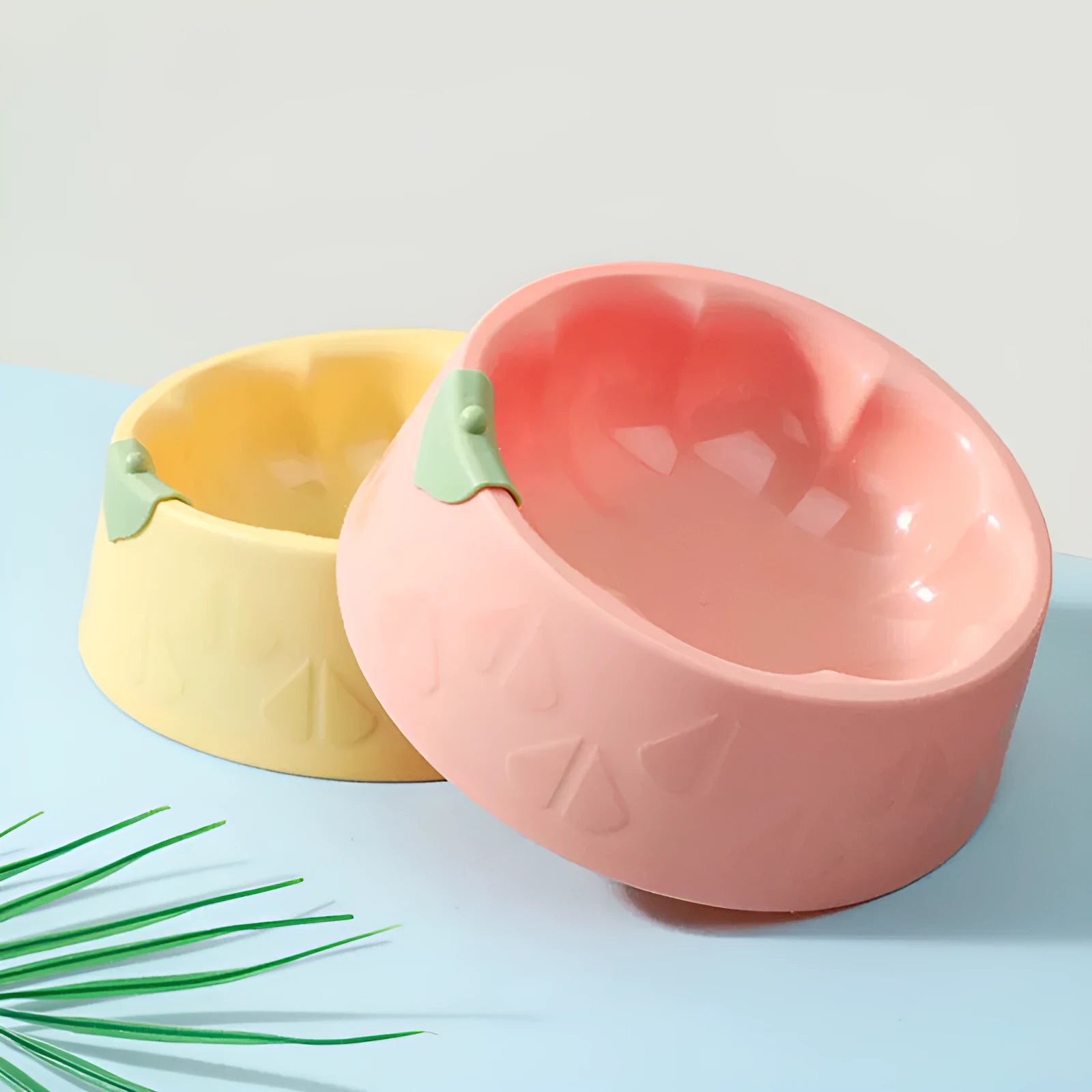 Green plastic double pet bowl for cats and dogs with anti-tipping base and separate food and water compartments