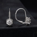 Silver flower bud shaped clip-on earrings with a white gold plated finish and a central moissanite stone.