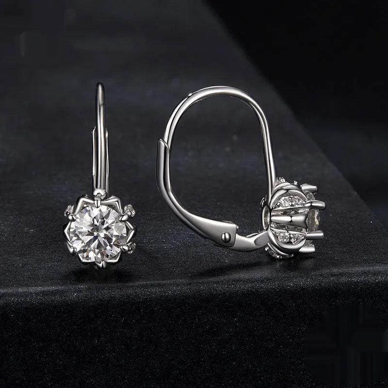 Silver flower bud shaped clip-on earrings with a white gold plated finish and a central moissanite stone.