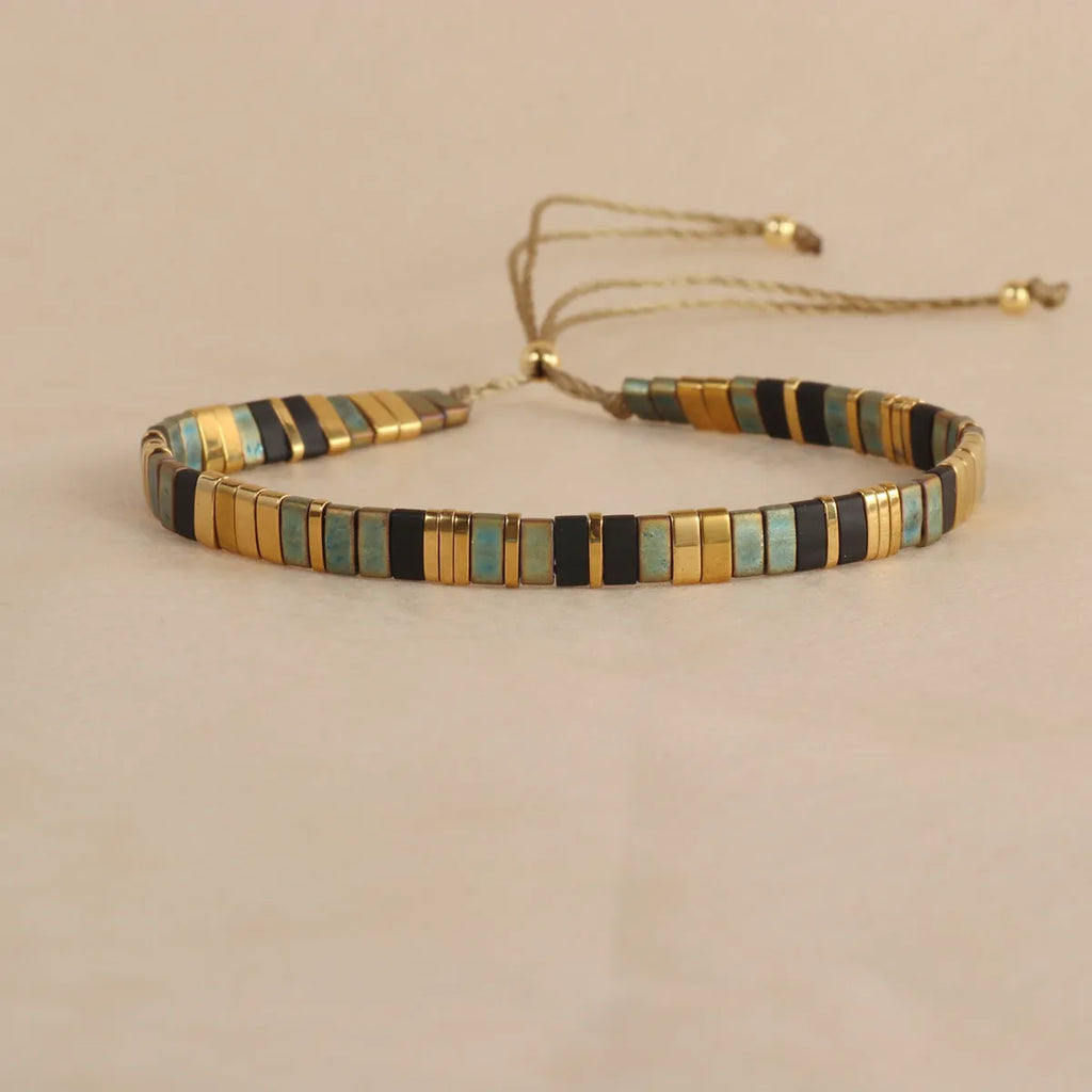 Geometric glass bead pull bracelet in retro green, black, light blue, red, and milky white colours.