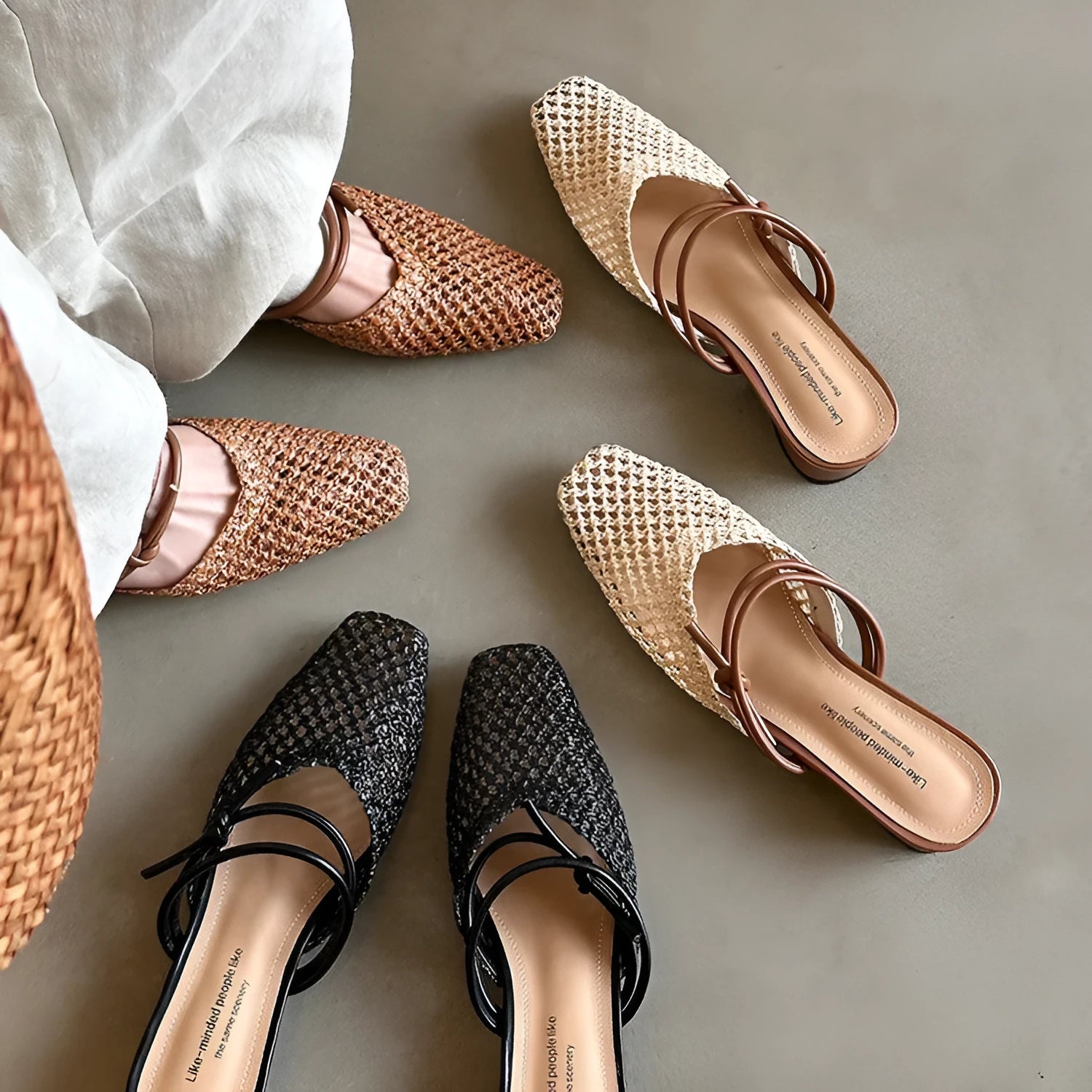 Women's black retro slippers with a square toe, chunky heel, and breathable hollow-out design on a rubber sole.
