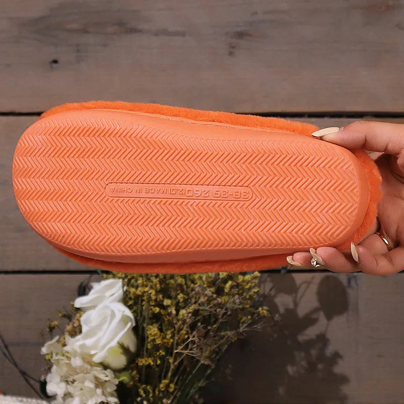 Orange Halloween pumpkin slippers with plush lining and textured PVC sole.