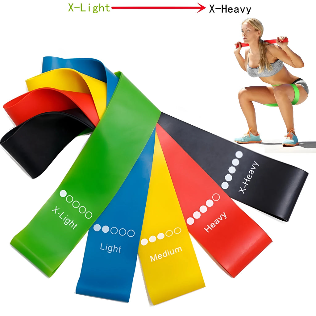 Five yoga resistance bands in different colours with varying thickness for progressive fitness training