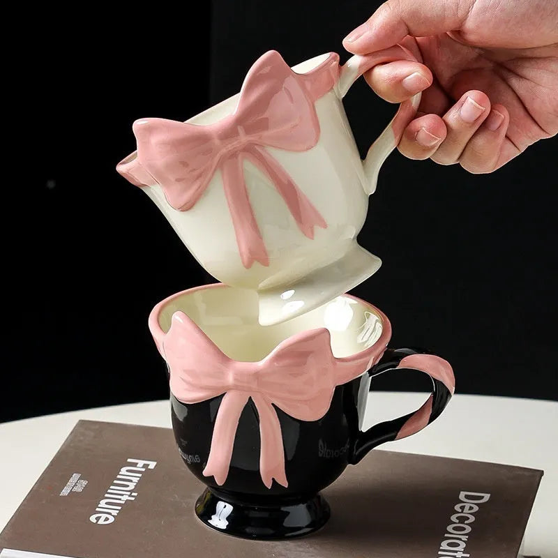 Heart-shaped ceramic mug with decorative bow design in white powder or black pink colour