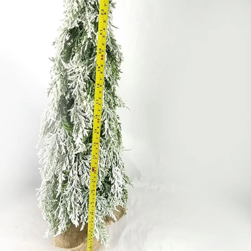 Small 24-inch artificial Christmas tree with white PE snow spray finish, green branches, built-in lights, and a red ornament
