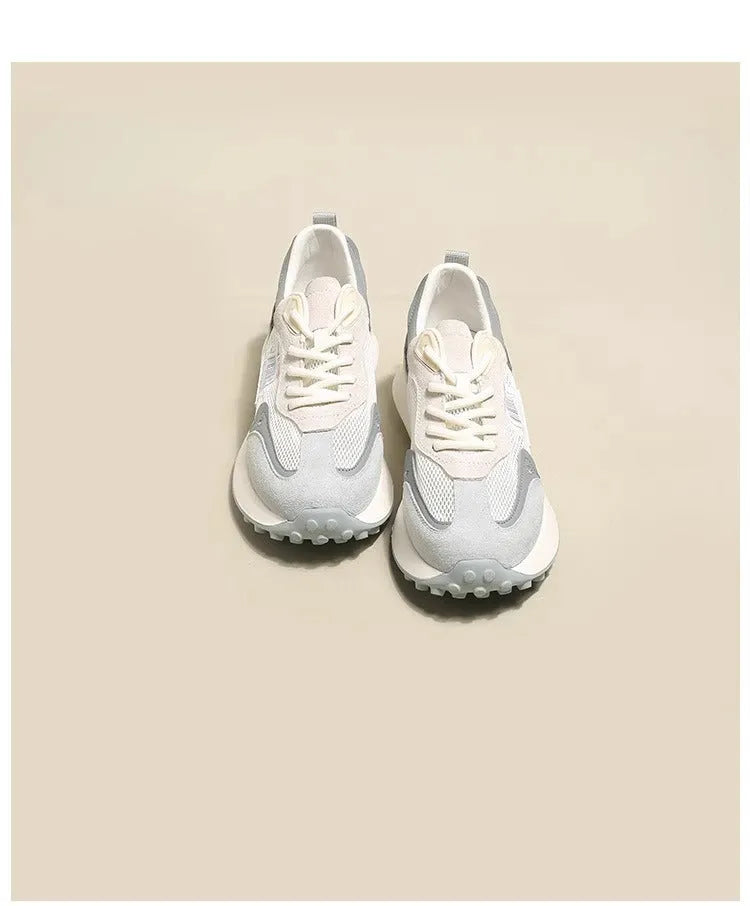 Women's grey and pink low-top retro sneakers with a round toe and flat rubber sole.