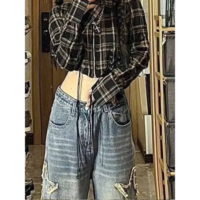 Blue high waist women's wide-leg denim trousers laid flat, showing straight leg cut and button fastening.