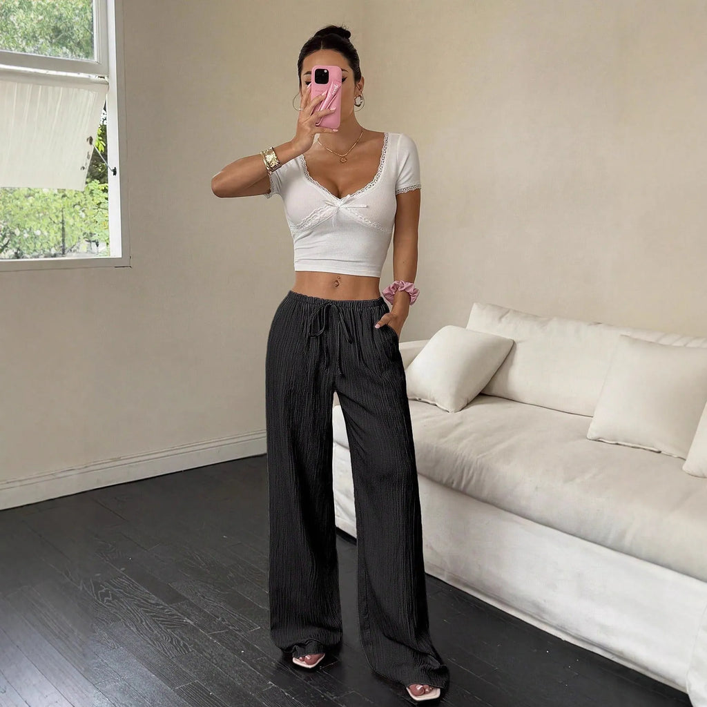 Women's wide-leg casual trousers with lace-up waist detailing in black or pink colour options