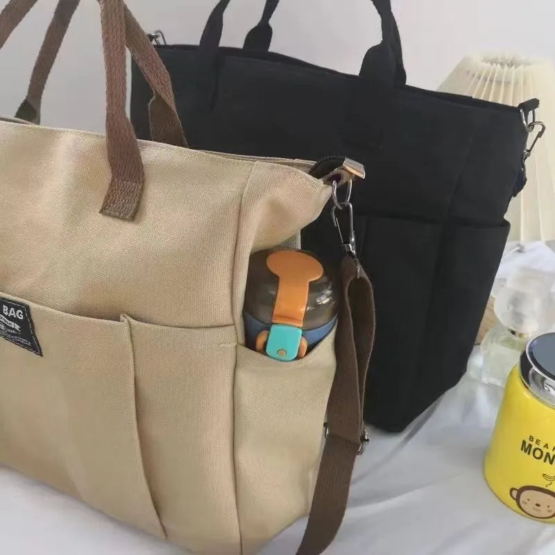 Canvas shoulder bag in khaki, 31cm wide, with handle and crossbody strap, urban simplicity style