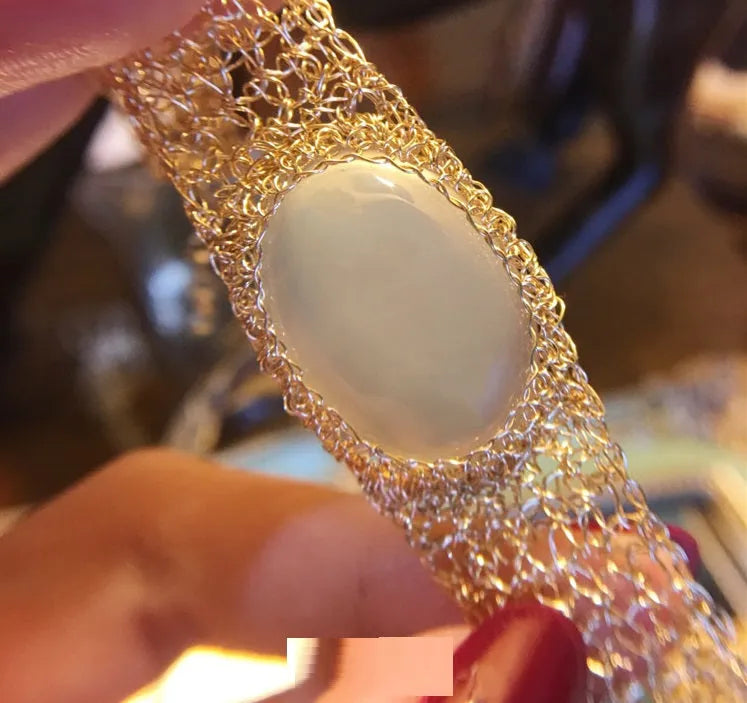 14k gold wire natural white chalcedony bracelet with adjustment chain on neutral background