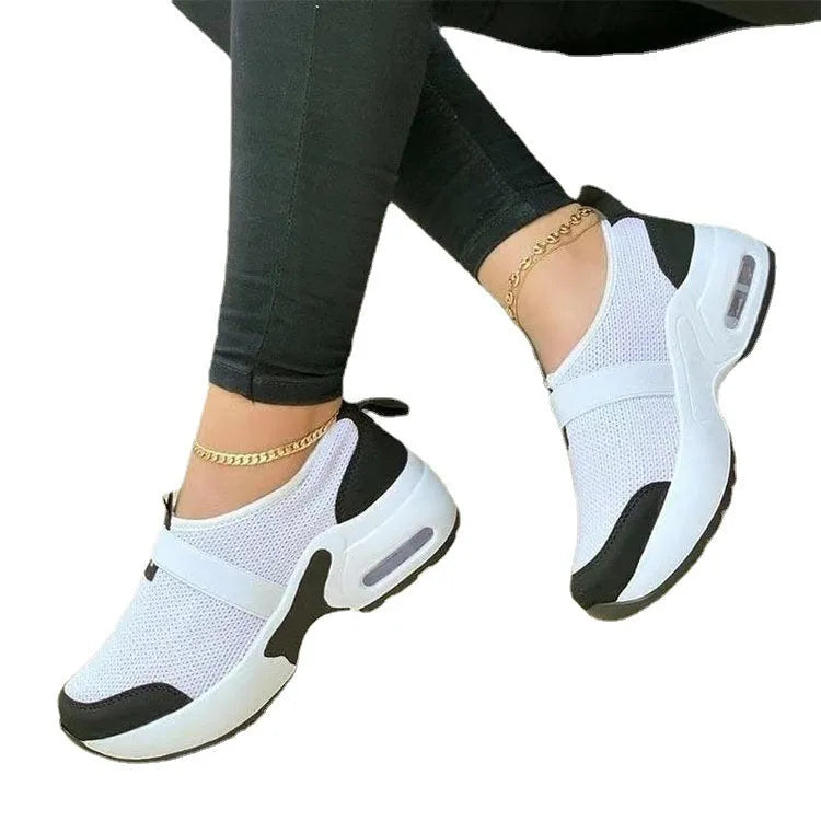 Women's flat mesh sneakers in light grey with white rubber sole and lace-up front.