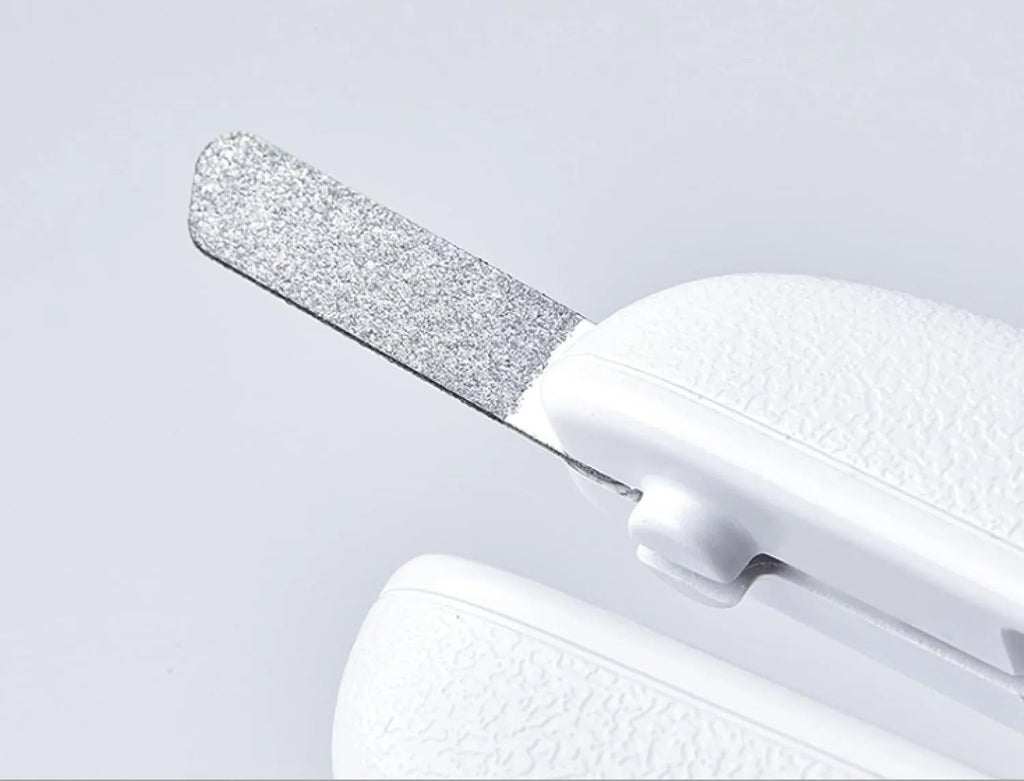 White pet nail clippers with LED light, transparent anti-splash guard open, and separate nail file.