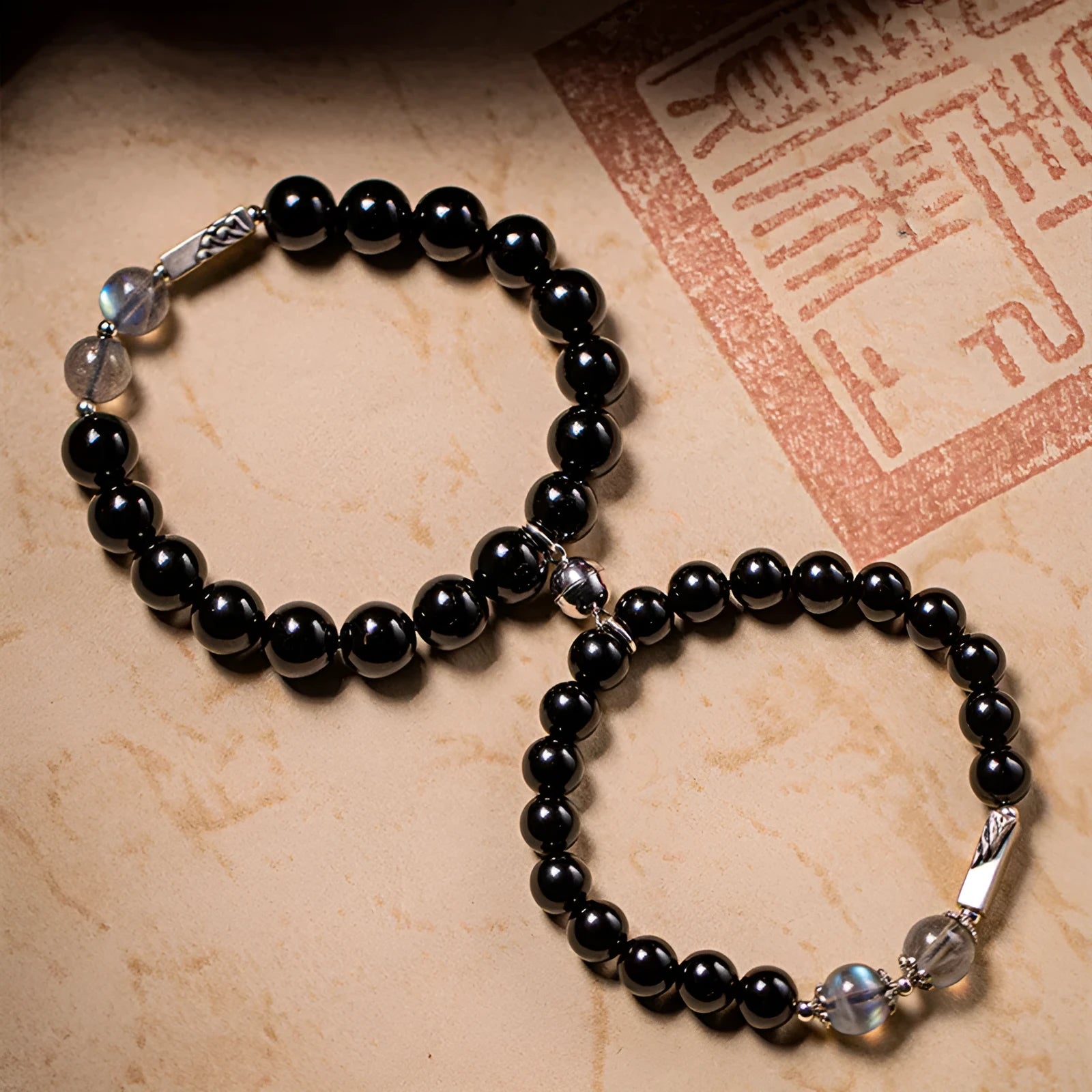 Obsidian Buddha beads couple bracelet set showing 8mm and 10mm bracelets in a national style.