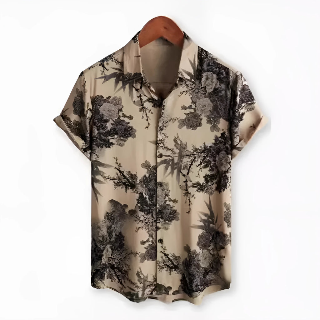 Man wearing a short sleeve Hawaiian shirt with a colourful floral print pattern.