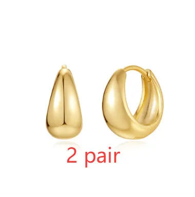 Golden geometric clip-on earrings with round design elements and electroplated finish