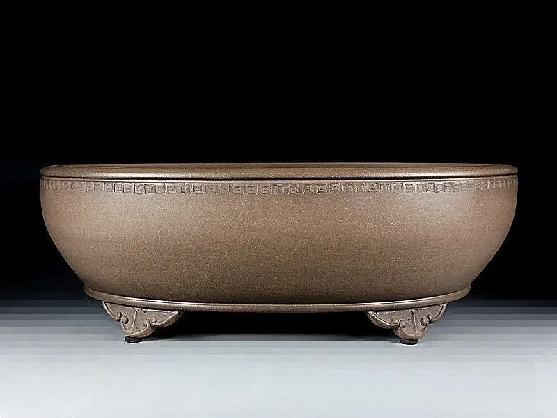 Handmade large oval purple sand flowerpot for plants on a desktop.
