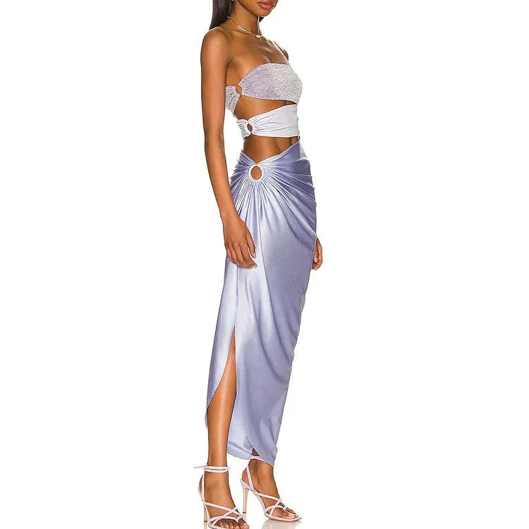 Purple one-piece swimsuit with a matching wrap skirt laid flat on a surface.