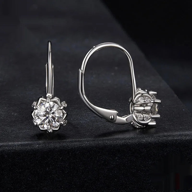 Silver flower bud shaped clip-on earrings with a white gold plated finish and a central moissanite stone.