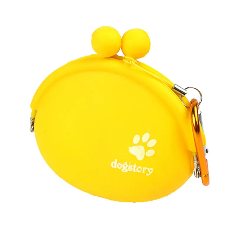 Yellow silicone dog training treat bag with hook-and-loop strap, shown attached to a waistband.