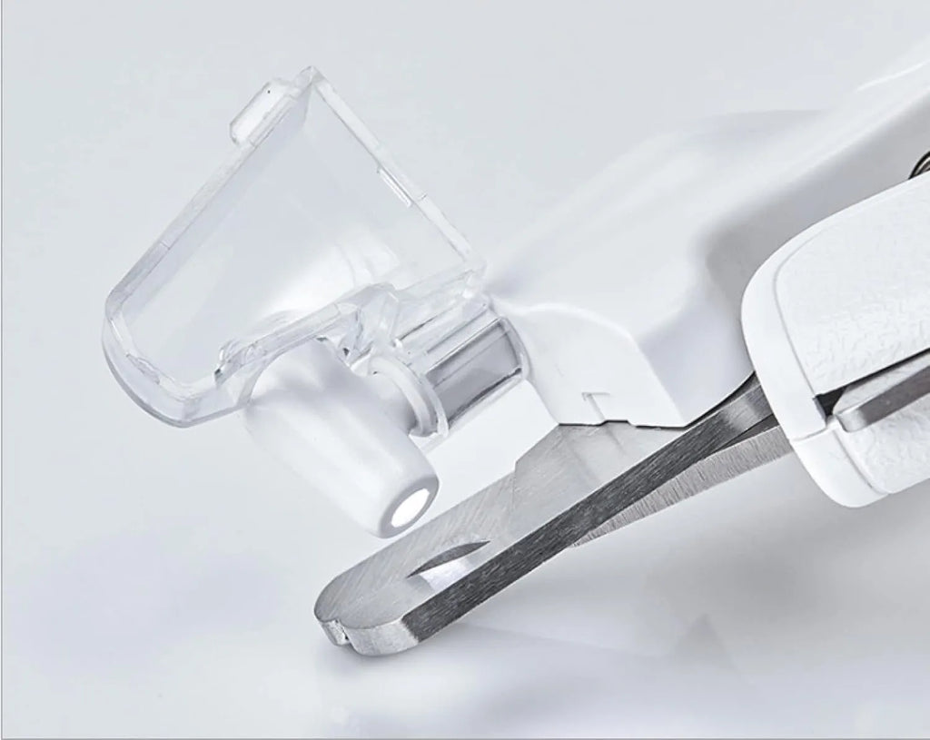 White pet nail clippers with LED light, transparent anti-splash guard open, and separate nail file.