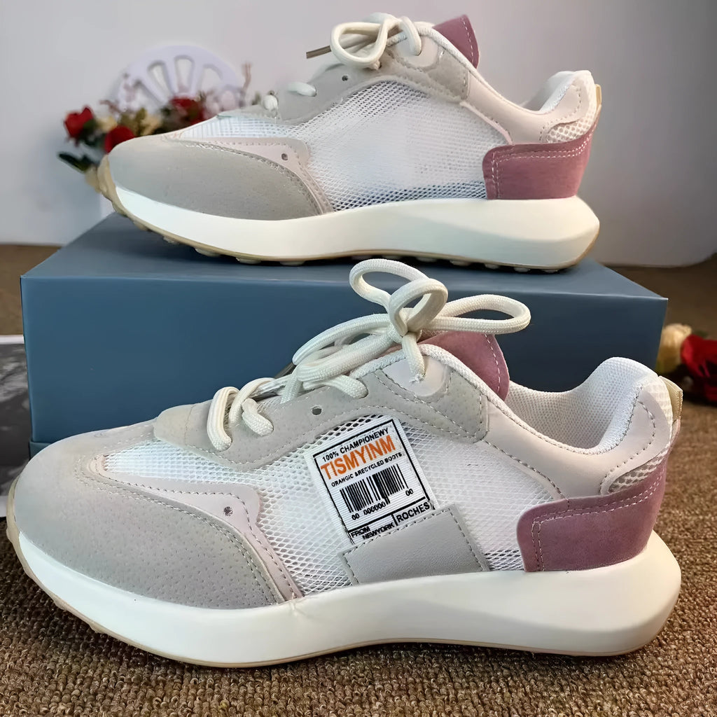 Women's grey and pink low-top retro sneakers with a round toe and flat rubber sole.