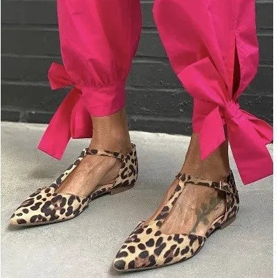 Leopard print women's pumps with pointed toe, chunky low heel, and cross shoulder straps