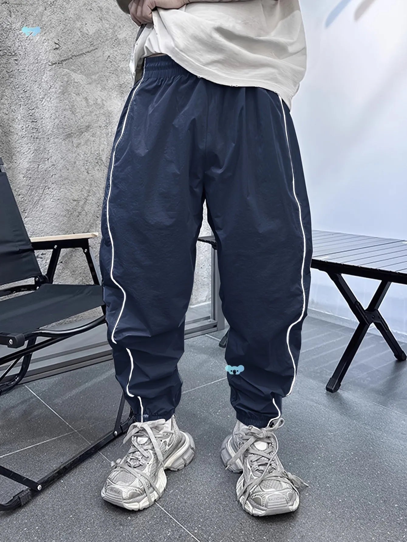 Man wearing loose-fit, cropped-length bamboo fibre sports trousers in Army Green colour.