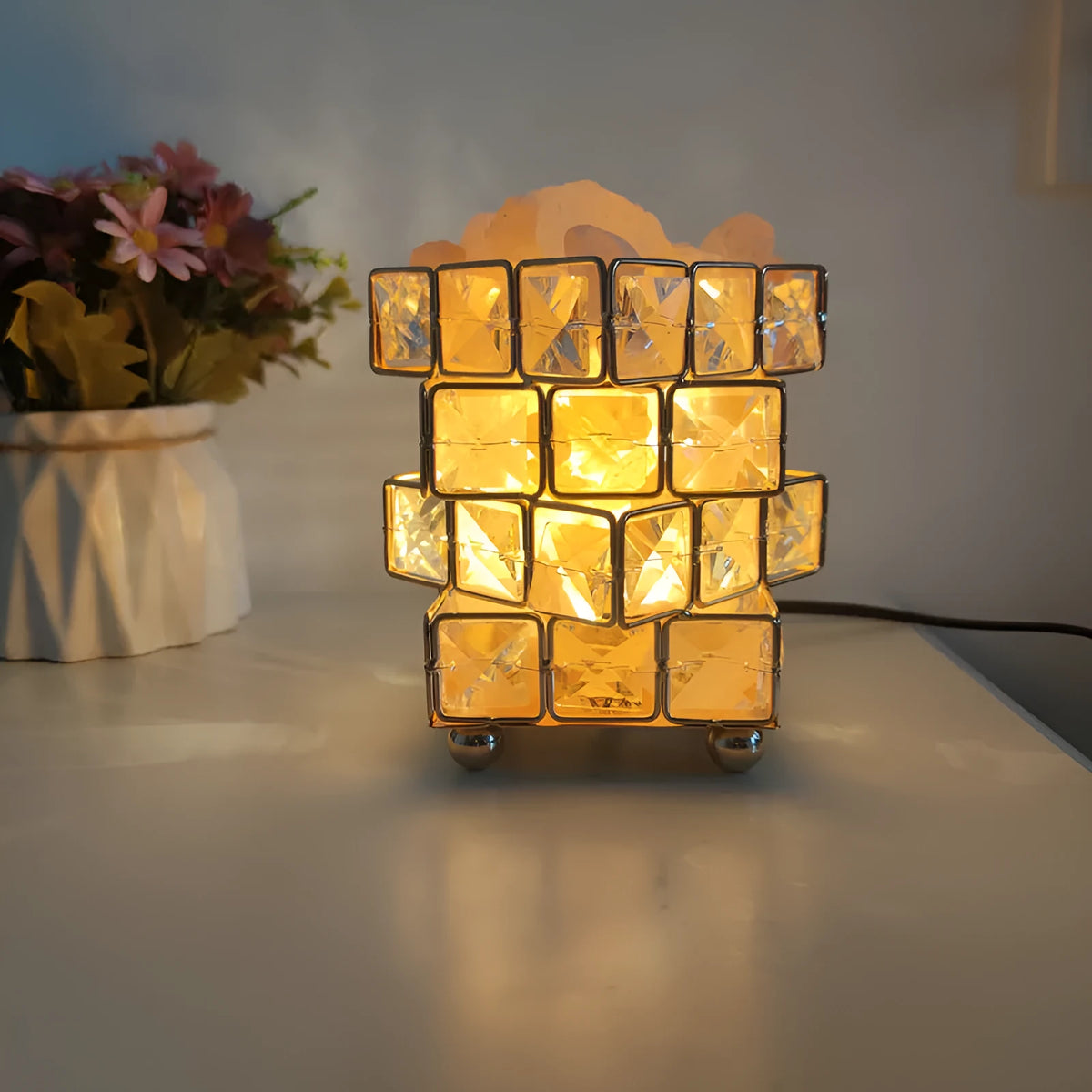 Himalayan crystal salt lamp with dimmer switch on wooden base emitting warm amber glow